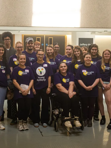 The Youth Voice Network smile as a group in a hall.