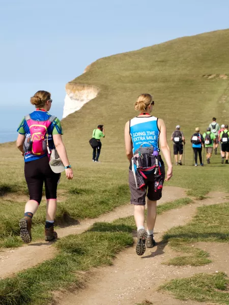 A group of hikers take on a coastal cliff trek.