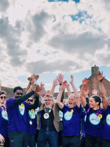 A group of Young Epilepsy supporters cheer at the end of a challenge event.