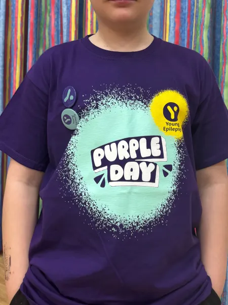 A young man wears a Purple Day.