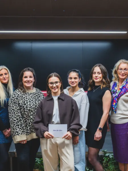 Panellists from Hear Her Voice 2026 stand in a line for a photo.