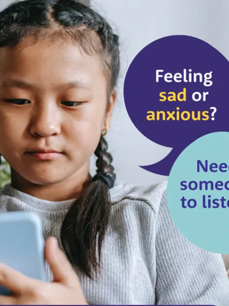 A poster shows a girl texting the Shout helpline.